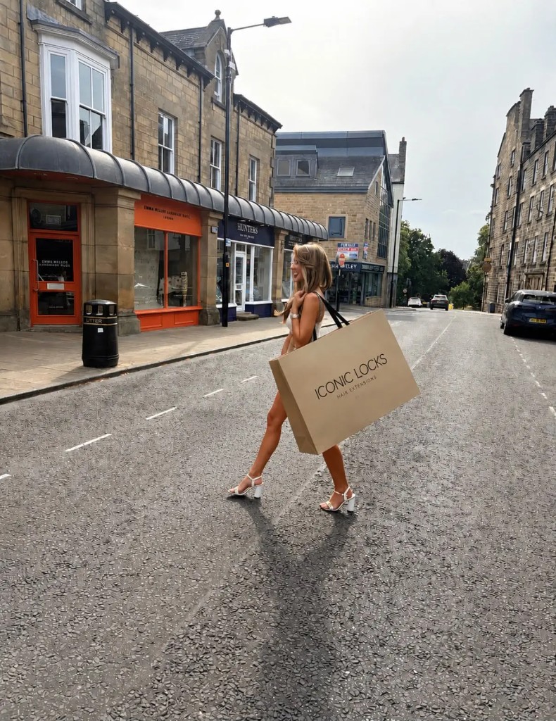 Woman carrying an Iconic Locks shopping bag